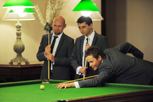 Groomsmen playing pool