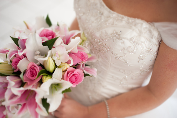 Closeup of wedding gown and flowers