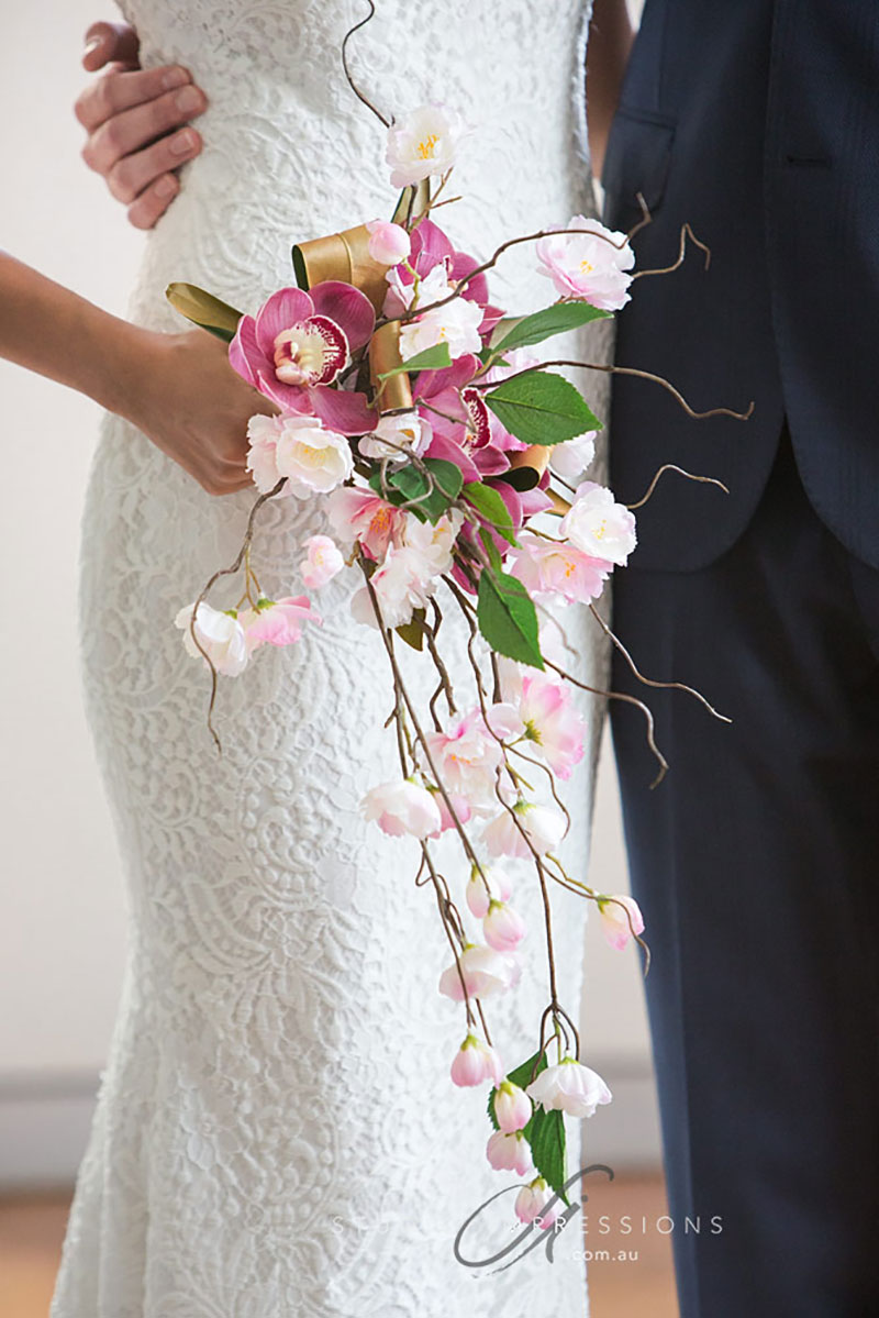 Bride holding a combined silk and fresh wedding bouquet.