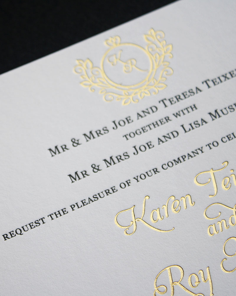 Gold foil letters and wreath letterpress invitations.