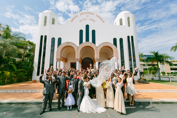 Wedding party kisses after ceremony