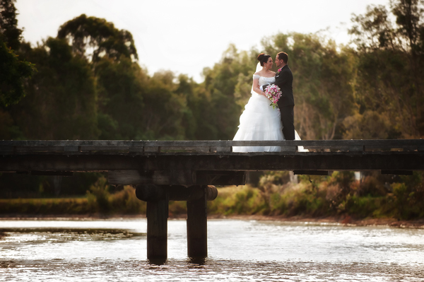 Bridal couple on bridge professional shot