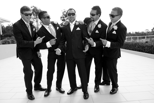 Black and white photo of groomsmen having fun