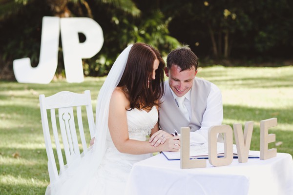 Happy couple signing the wedding certificate