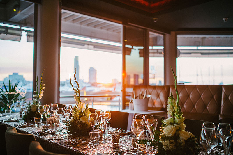 Table set for a wedding reception at Glass Dining & Lounge Bar with a view of the Gold Coast city skyline.