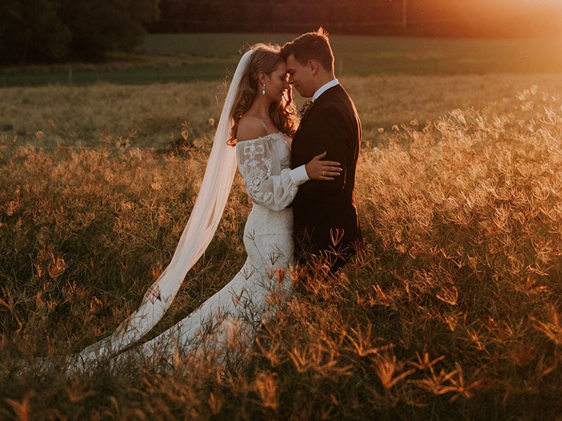 Bride and Groom together, with bride wearing a When Freddie Met Lilly gown.