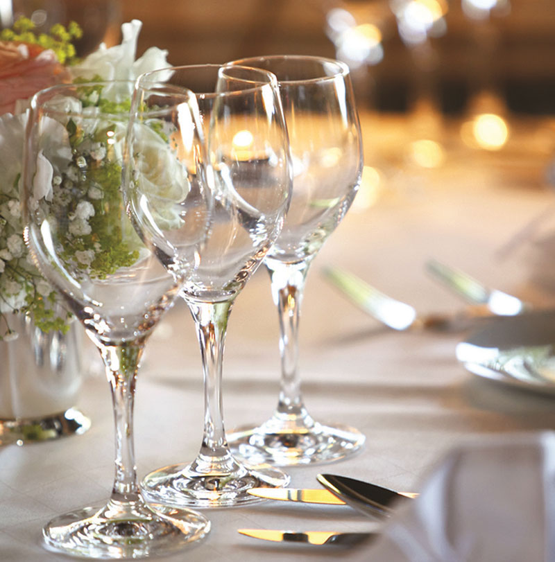 Wine glasses on a table set for a wedding reception at the Hellenic Club.