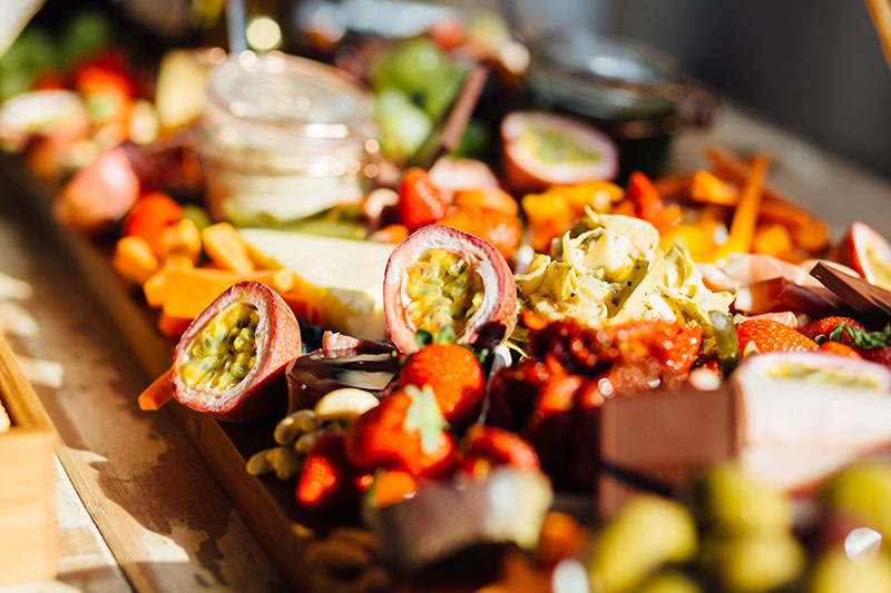 Grazing table laiden with lots of colourful food