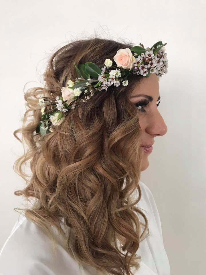 bride wearing a floral crown with long romantic curls created by Inside Hair.