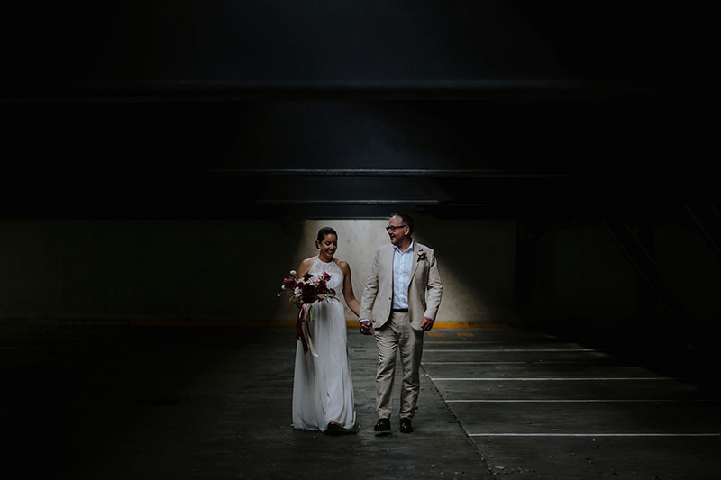 Bride & Groom, Mayumi + Sam holding hands.