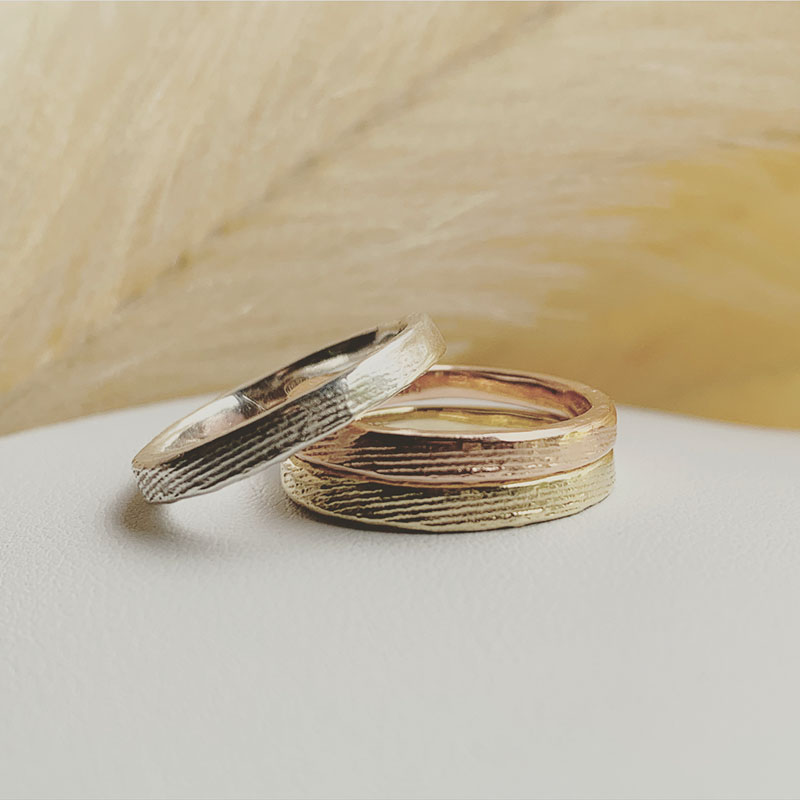 Wedding rings featuring a cuttlefish cast texture, handcrafted by Journey Of A Wanderess.