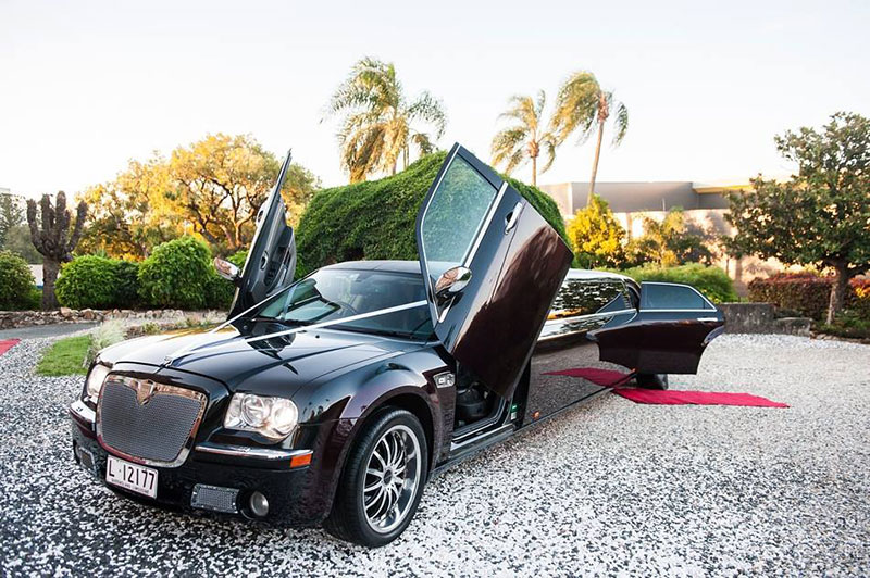 Black/brandy Chrysler 300C Super Stretch Limousine with doors open.