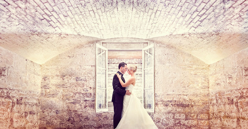 Bride and Groom holding each other in a room.