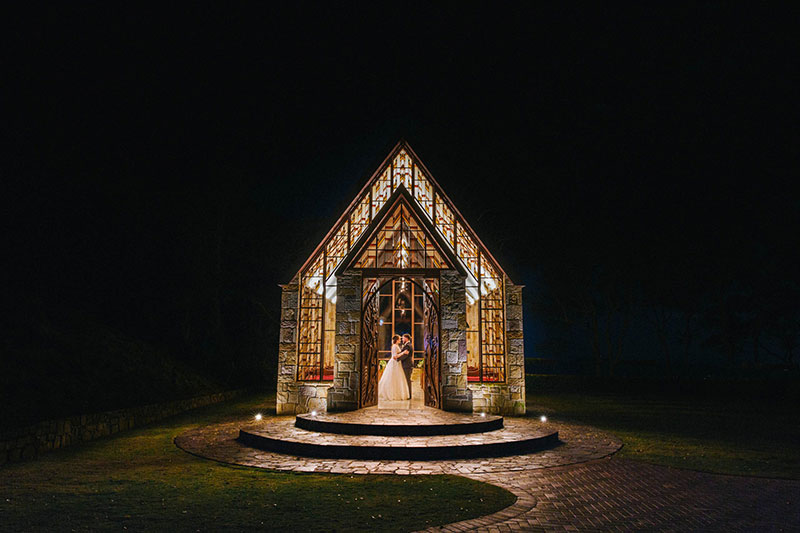 Bride and Groom in a beautiful chapel at night.