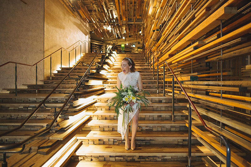 Excited Bride walking down unique looking steps.