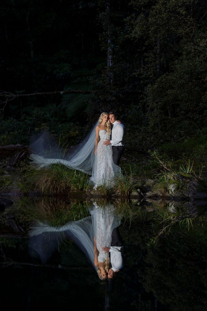 Photo taken by Leigh Warner Weddings of Bride and Grooms reflection captured in the water.