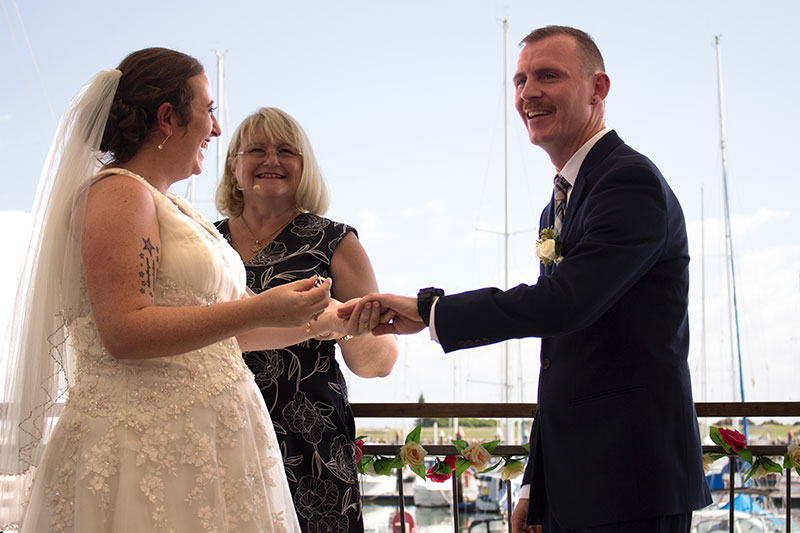 Bride and Groom exchange rings at their wedding ceremony.