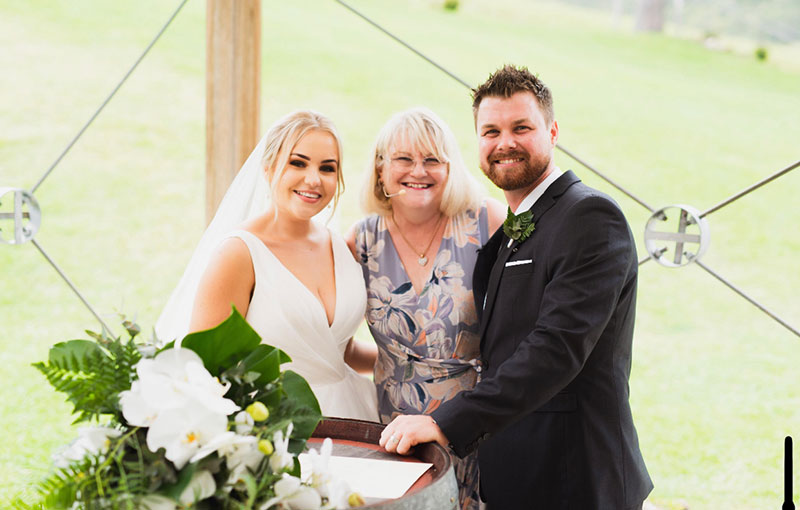Annette Richards Celebrant posing with a happy Bride and Groom in an outdoor setting.
