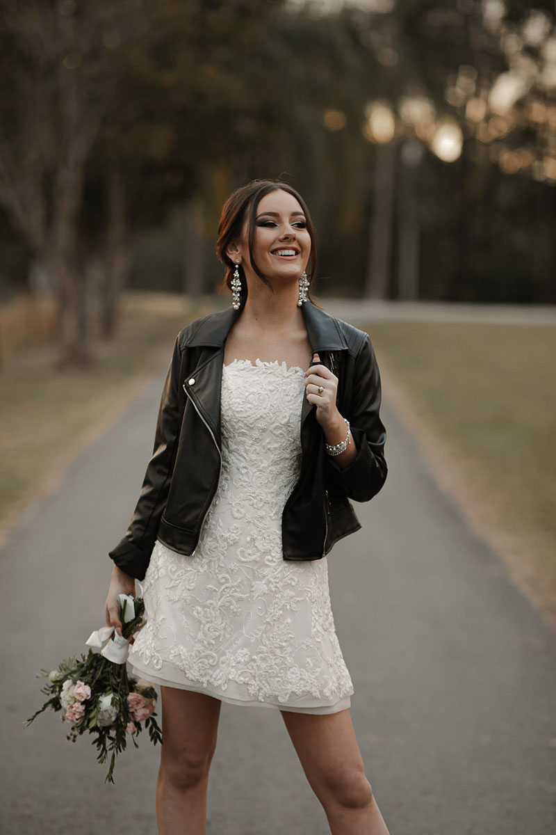 Photo by Tom Judson Photography of model wearing party dress without organza underskirt, and a black leather jacket.