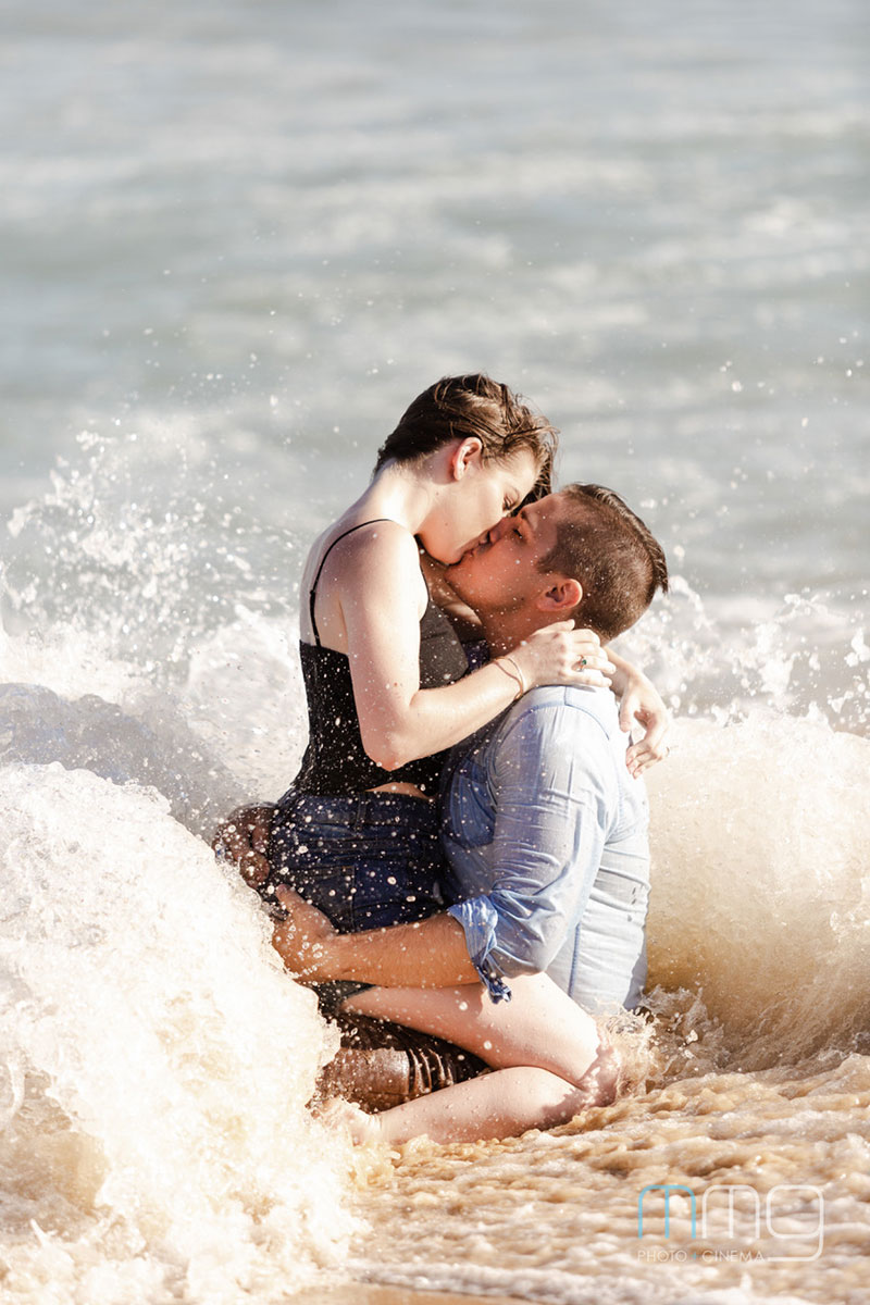 Couple sitting together in the surf.