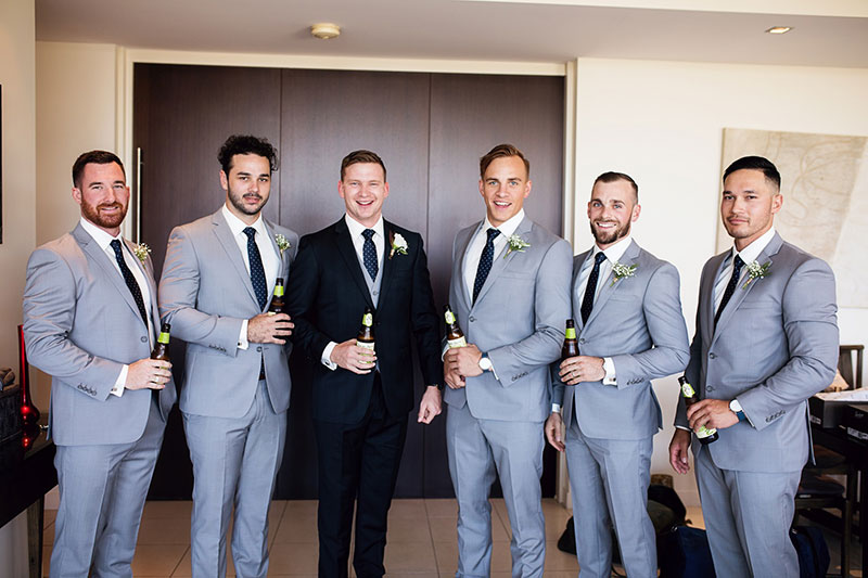 Groom in black with his Groomsmen in light grey suits.