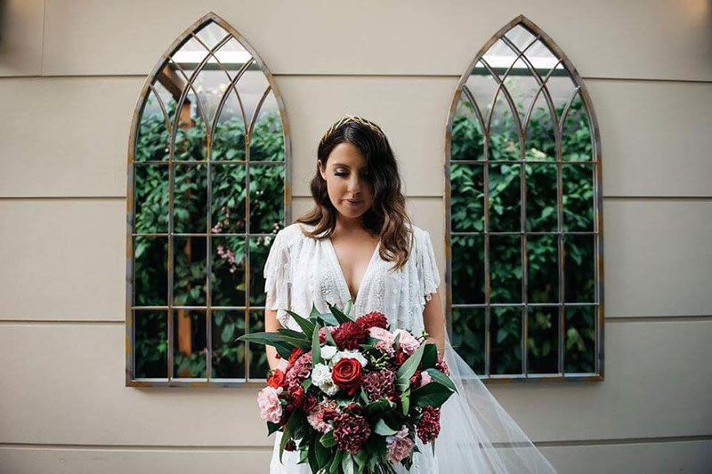 Bride holding gorgeous large wedding flower bouquet.