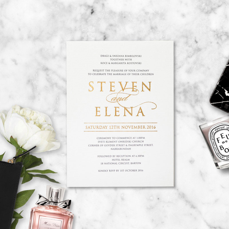 White and gold wedding invitation.
