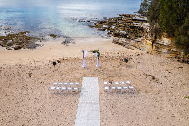 Drone Photography captures a beautiful beach wedding ceremony setting.