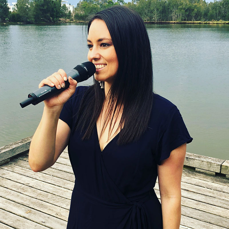 Ella the Marriage Celebrant speaking with a microphone.