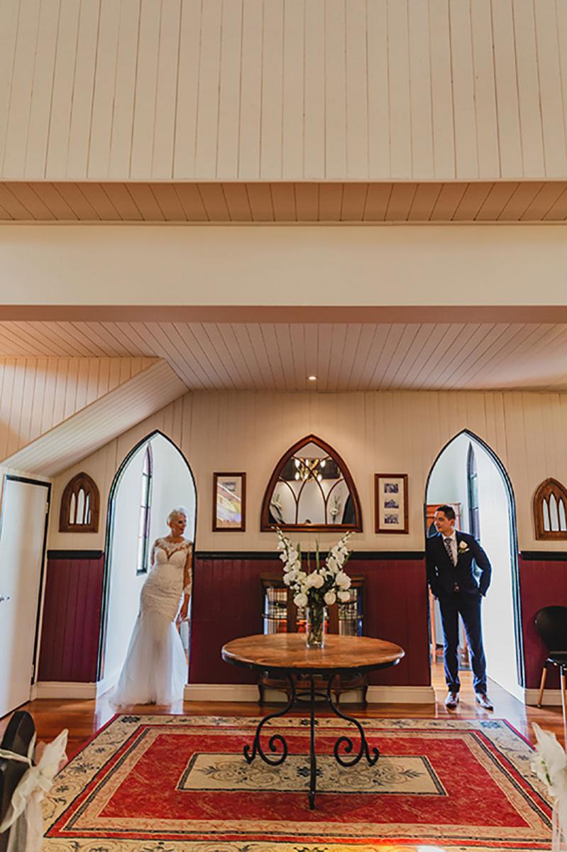 Bride and groom inside the entrance to Broadway Chapel.