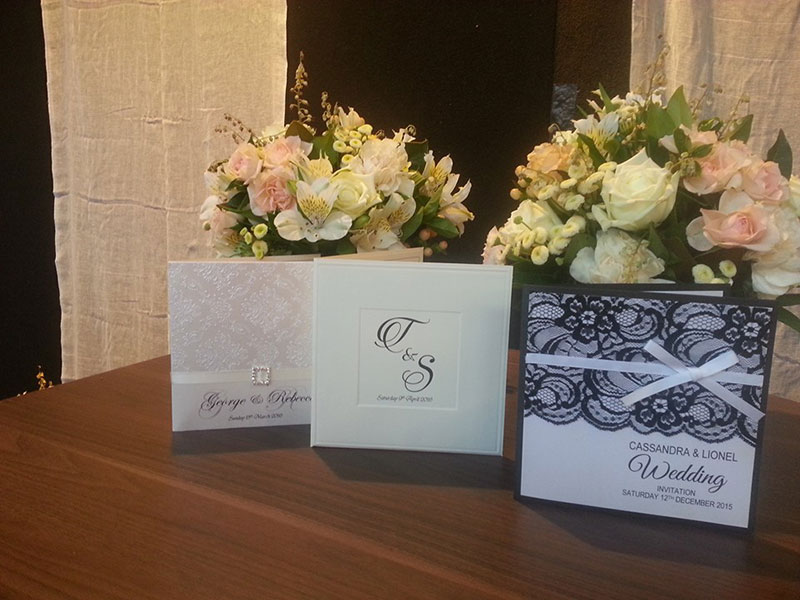 Three different styled wedding invitations.