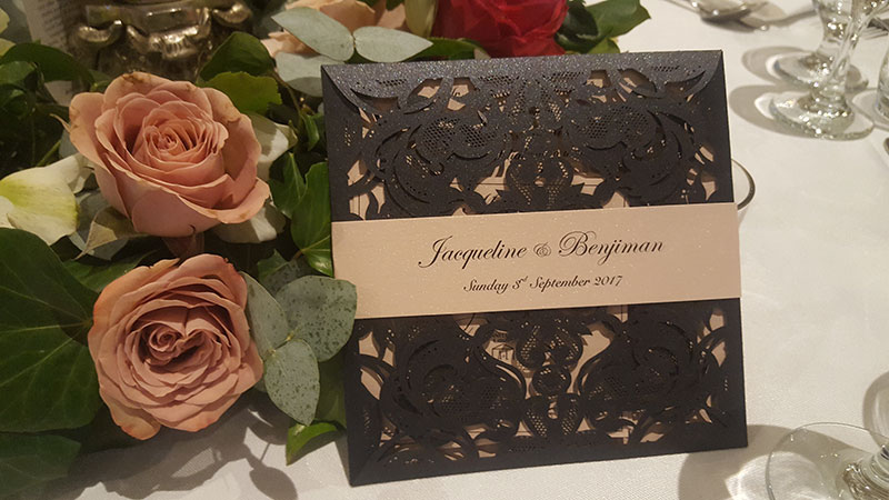 Black laser cut wedding invitation.