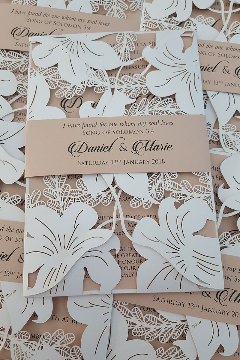 White laser cut wedding invitations.