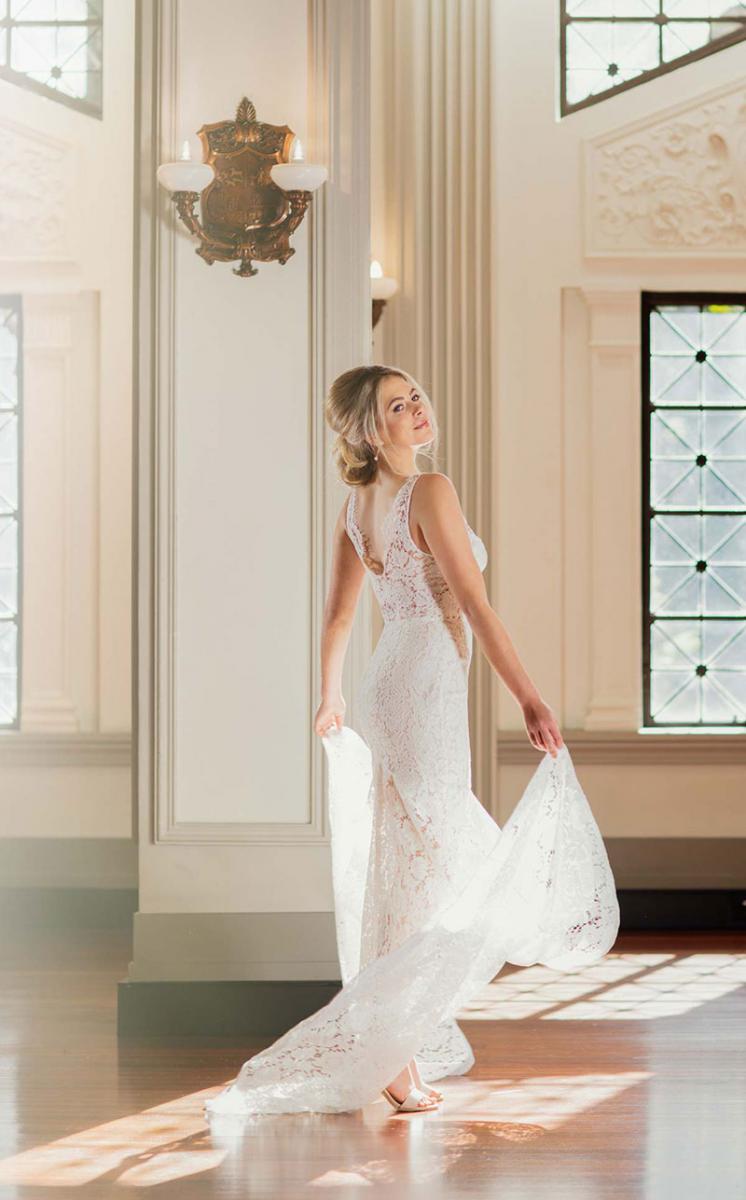 Bride showing the back view of her lace Fiorenza wedding gown.