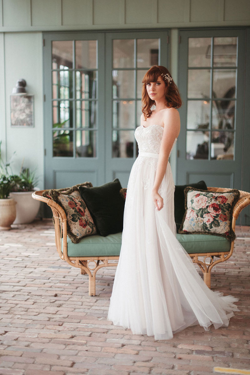 Strapless wedding gown worn by bride.