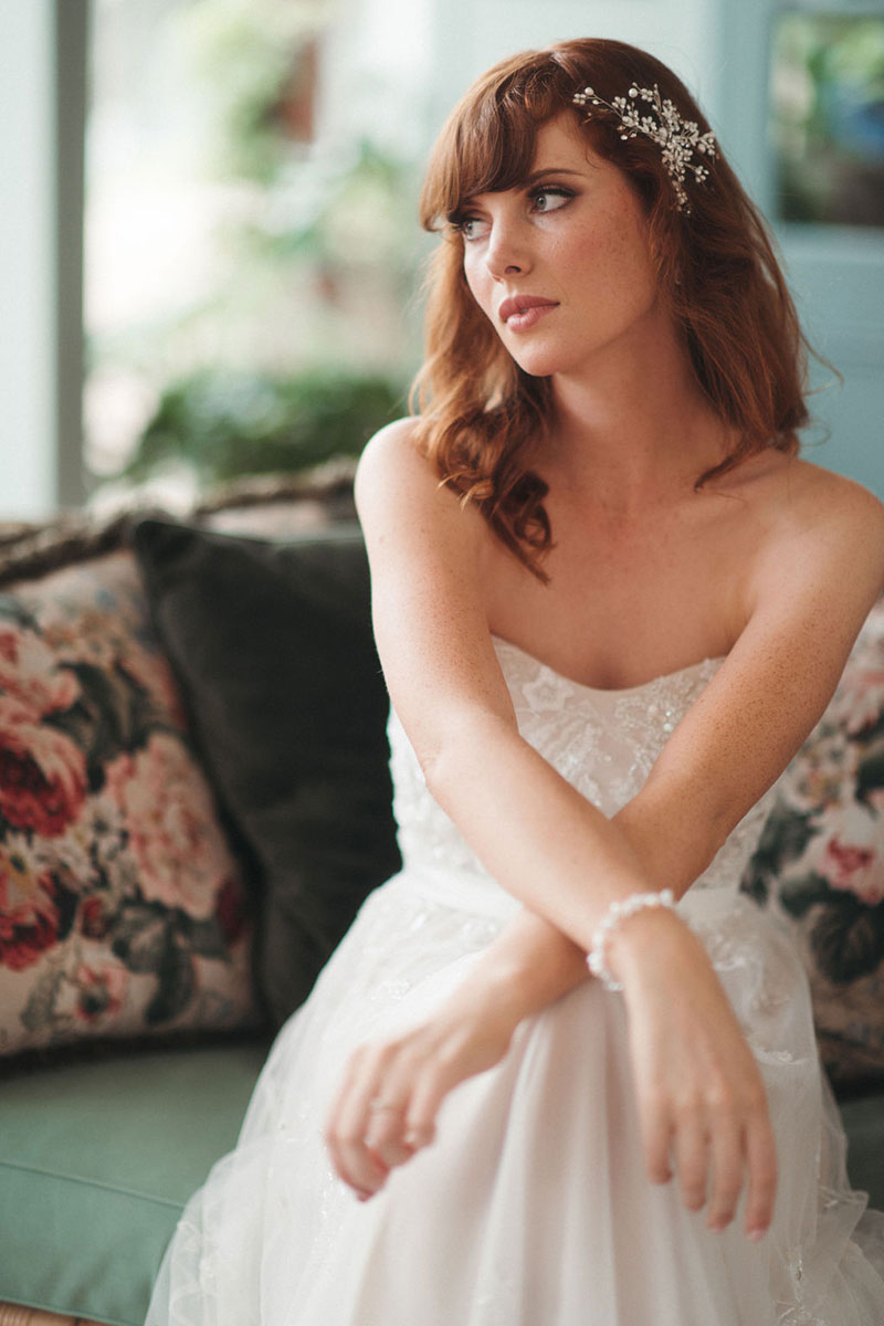 Bride sitting down in a strapless wedding dress.