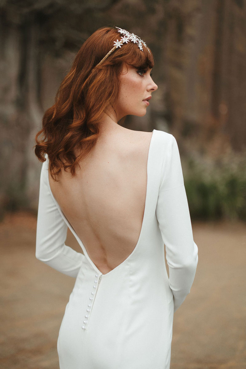 Bride wearing a low scooped back wedding dress.