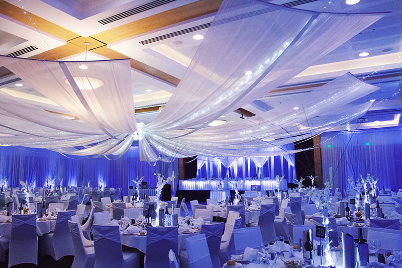 Hellenic Club set up for a wedding with stylish draping and lighting.
