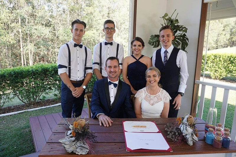 Happy married couple with their wedding party after their ceremony.