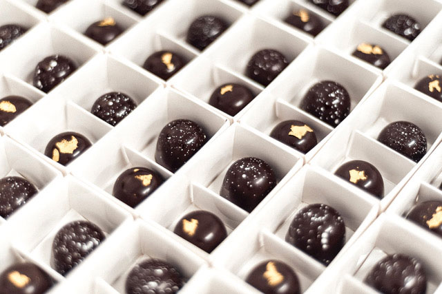 Lots of Little Cocoa chocolates, each in a separate compartment in a large white giftbox.