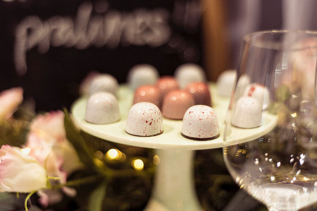 Little Cocoa white and pink coloured chocolates set on a serving pedestal.