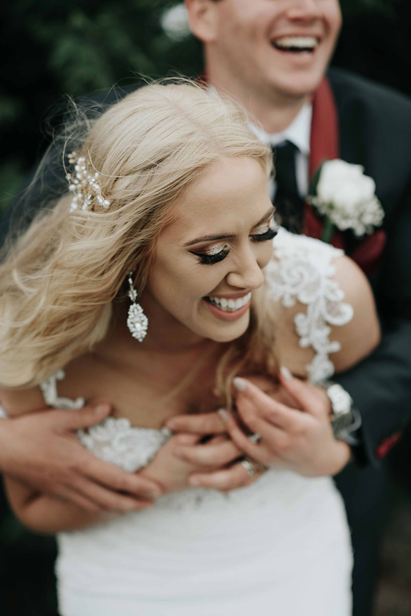 Happy bride and groom laughing.