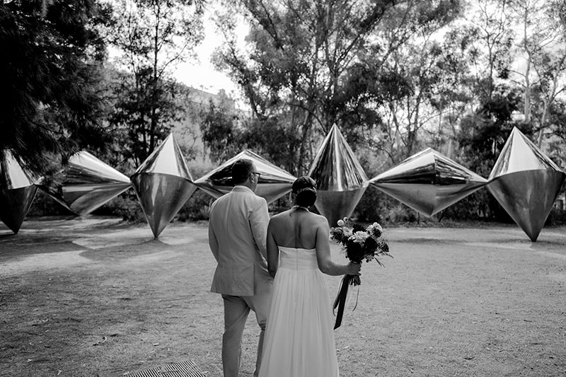 Mayumi + Sam facing a sculpture at the National Gallery of Australia.