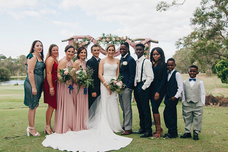 Happy Bride, Groom and wedding party in the gardens of McLeods Country Golf Club.