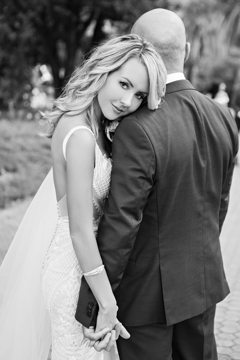 Bride looking at camera with Groom facing the other way.