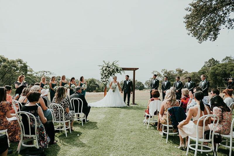 Couple getting married by Nicole Penning Civil Celebrant in an outside ceremony.