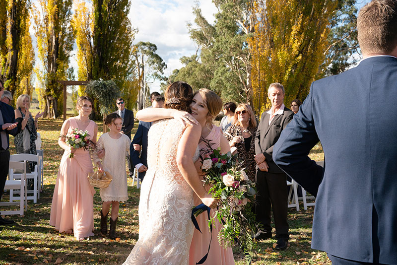 Candid wedding photography showing guests congratulating bride.