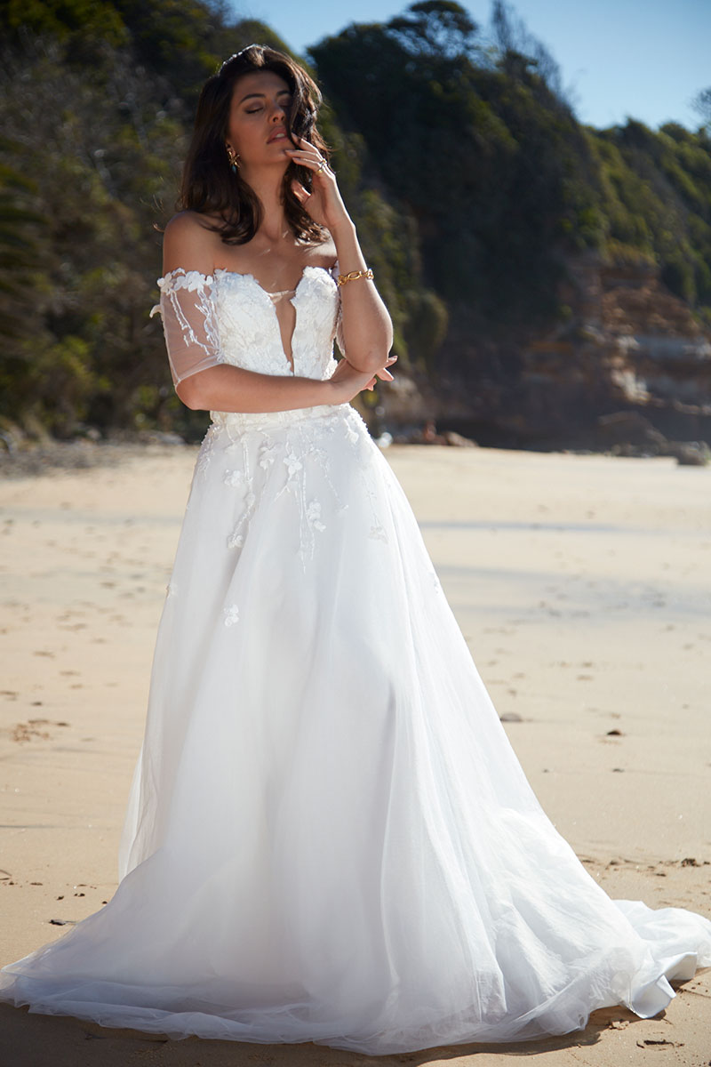 Model at the beach, wearing Angelina by Sarah Joseph Couture.