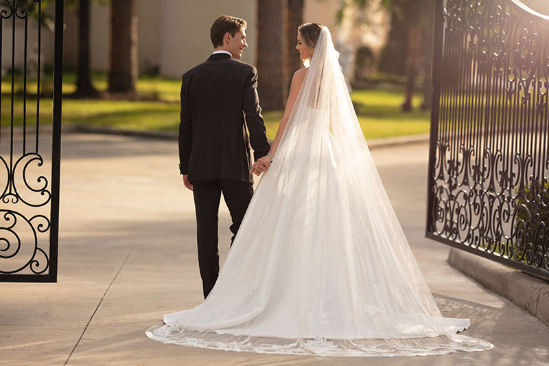 Bride and Groom walking through gates.