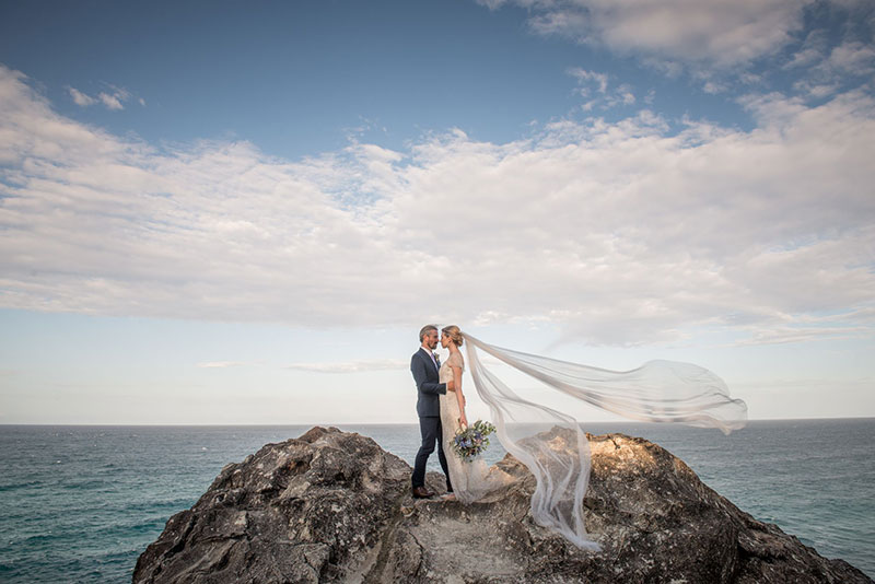 Bride and Groom perched on a rock at Stradbroke Island.